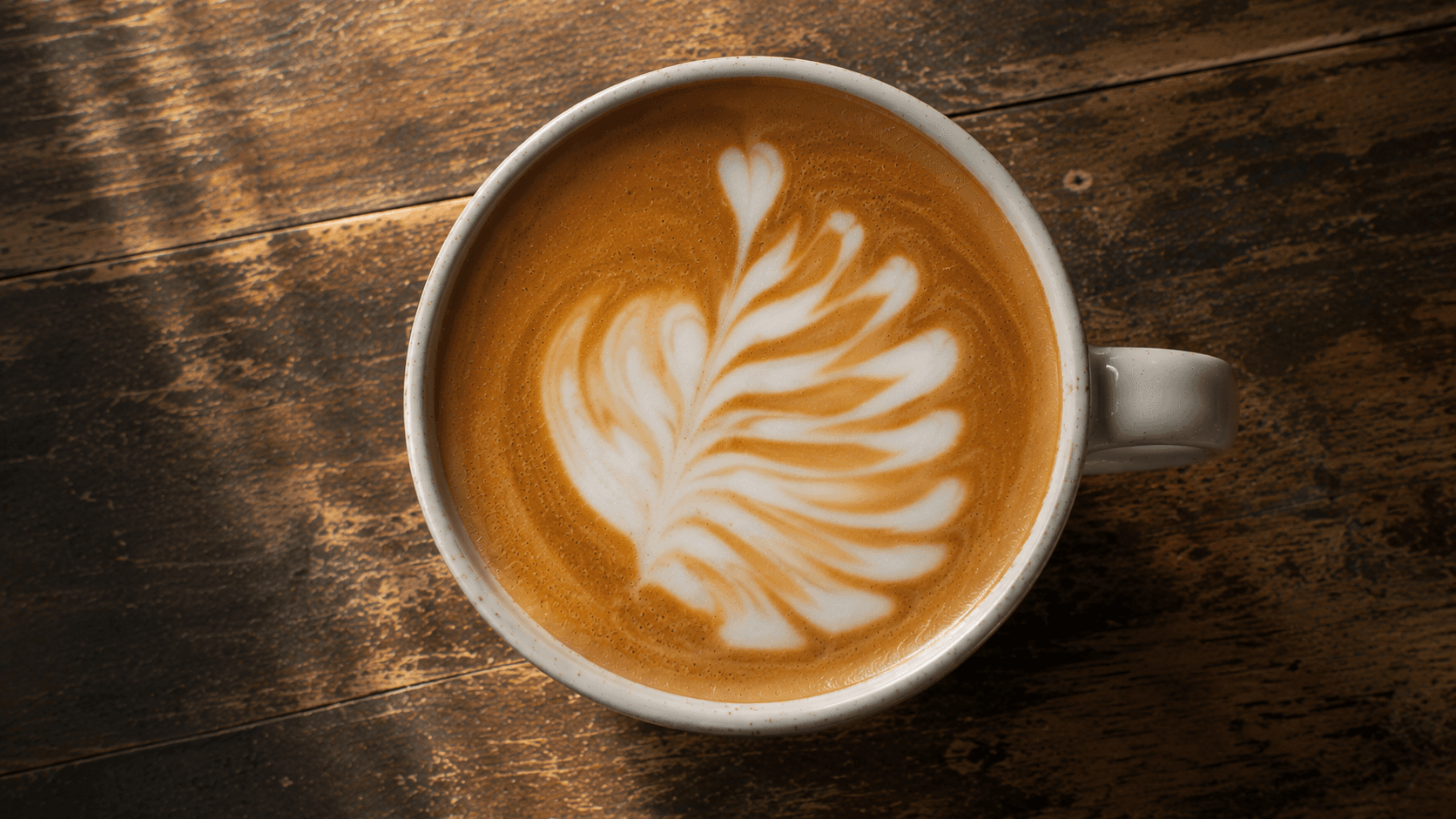 Latte art phoenix tail with bunched drops and uneven fan shape — common advanced mistake